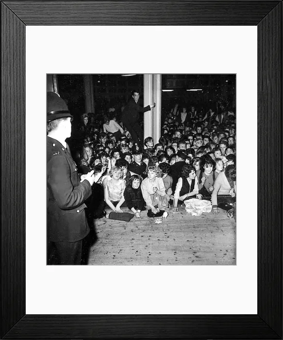 Framed Print : A policeman keeps watch on the rowdy audience during the Beatles Framed Print : A policeman keeps watch on the rowdy audience during the Beatles