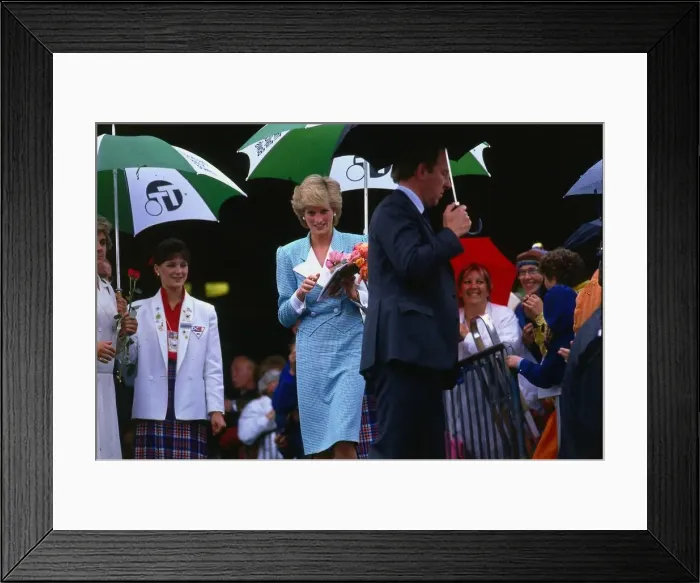 Framed Print : Princesss Diana, Princess of Wales, sheltering from the rain during a walkabout in Framed Print : Princesss Diana, Princess of Wales, sheltering from the rain during a walkabout in