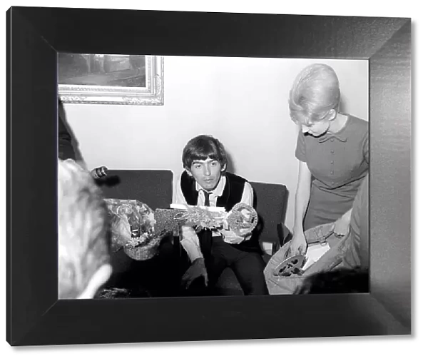 George Harrison, 21st birthday, with fan-club secretary helping him sort through the 52