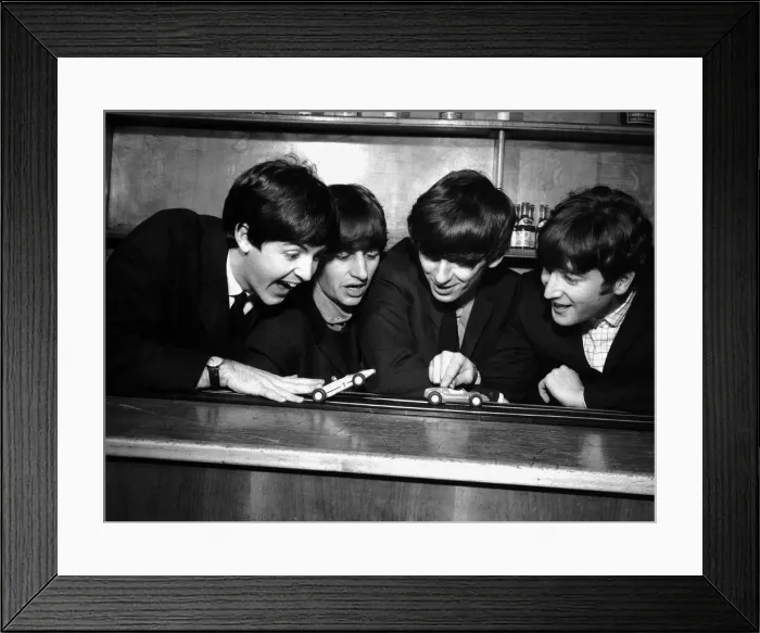 Framed Print : The Beatles in Coventry, amusing themselves with a miniature car race track before their Framed Print : The Beatles in Coventry, amusing themselves with a miniature car race track before their