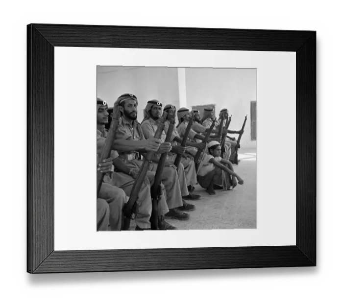 Framed Print : Members of the Abu Dhabi defence force pose for the camera with a young boy in Framed Print : Members of the Abu Dhabi defence force pose for the camera with a young boy in