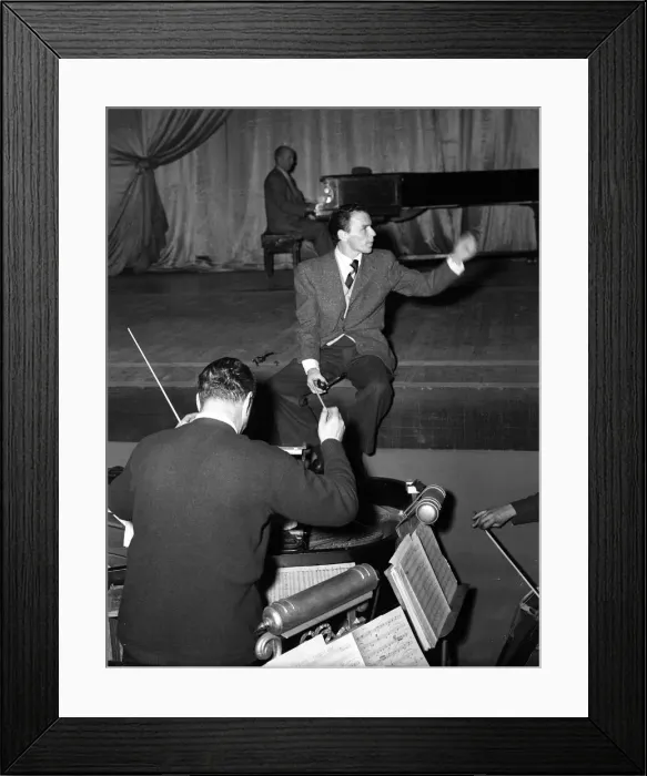 Framed Print : American singer and film star Frank Sinatra sitting on stage during rehearsals Framed Print : American singer and film star Frank Sinatra sitting on stage during rehearsals