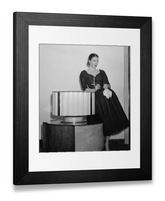 Framed Print : Amerivan actress Ava Gardner holding a cigarette holder at a press reception in London