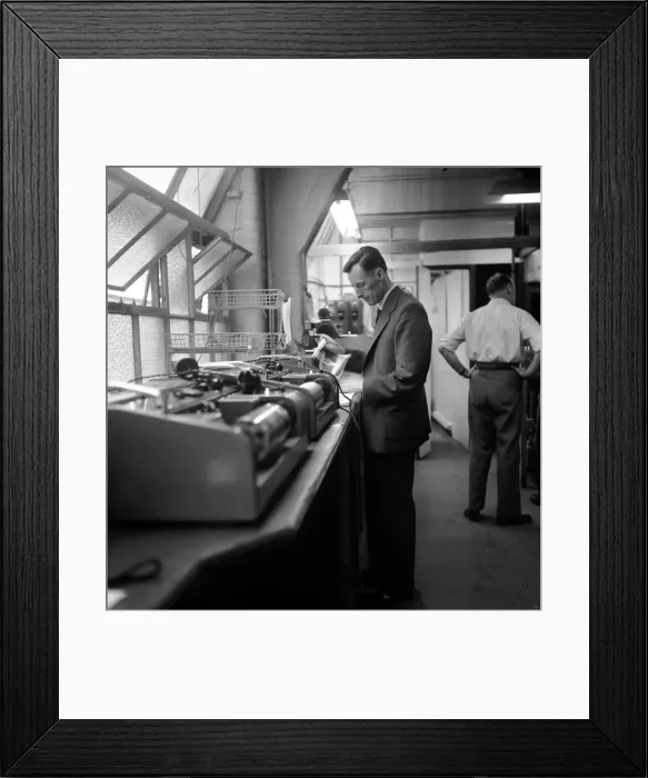 Framed Print : Bernard Coster, Daily Mirror Telephoto Room technician, seen here at work Framed Print : Bernard Coster, Daily Mirror Telephoto Room technician, seen here at work