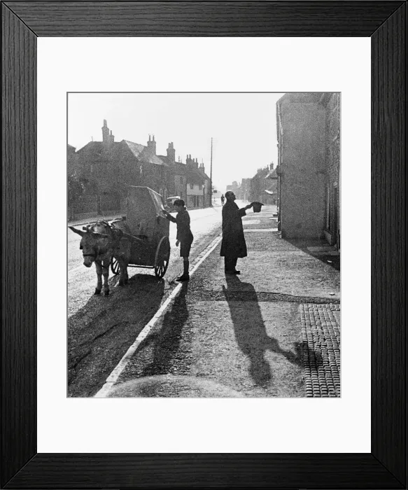 Framed Print : A boy operates a barrel organ mounted on a donkey and cart Framed Print : A boy operates a barrel organ mounted on a donkey and cart