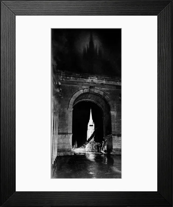 Framed Print : Through the suspension bridge arch under which two girls shelter All Saints Church Framed Print : Through the suspension bridge arch under which two girls shelter All Saints Church