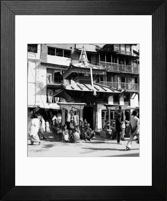 Framed Print : Shoppers pass a shrine to Buddah in one of the main roads leading off Durbar Square in Framed Print : Shoppers pass a shrine to Buddah in one of the main roads leading off Durbar Square in