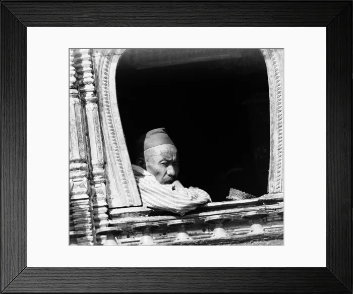 Framed Print : A man deep in thought looks out from a window of a buddhist temple in Katmandu, Nepal Framed Print : A man deep in thought looks out from a window of a buddhist temple in Katmandu, Nepal