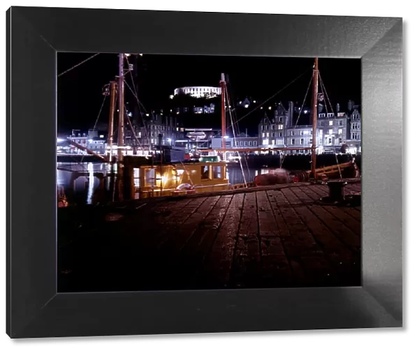 Fishing boats in harbour February 1979 at night in Oban scotland