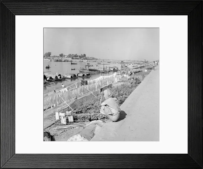 Framed Print : Boat people seen here hanging their washing out to dry on the muddy banks of Framed Print : Boat people seen here hanging their washing out to dry on the muddy banks of