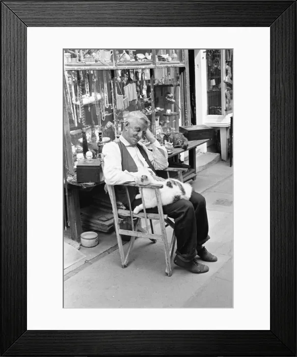Framed Print : An antique dealers dozing att his shop in The Lanes in Brighton July 1958 Framed Print : An antique dealers dozing att his shop in The Lanes in Brighton July 1958