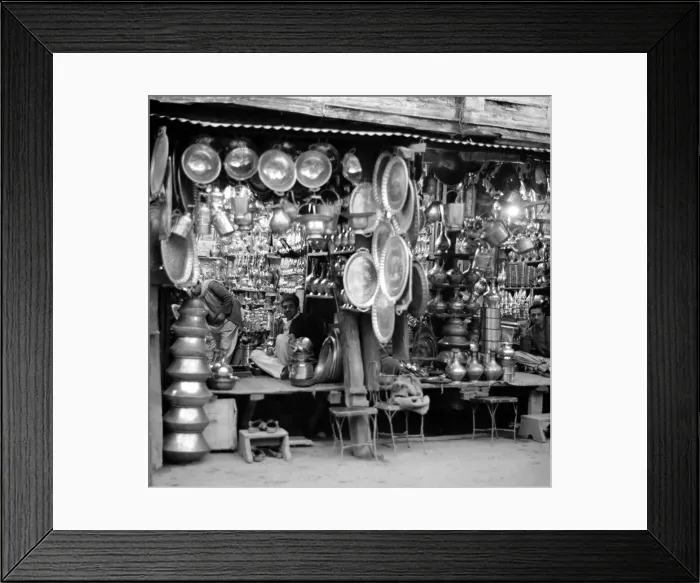Framed Print : Traders Ironmongers sit inside their shops in Peshawar amongst the pots and pans