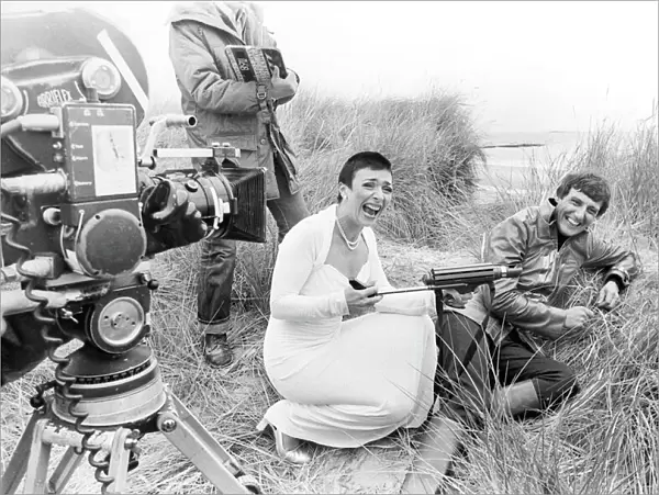 Actress Jacqueline Pearce as Servalan and Paul Darrow as Avon share a joke during filming