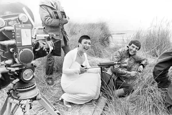 Actress Jacqueline Pearce as Servalan and Paul Darrow as Avon share a joke during filming