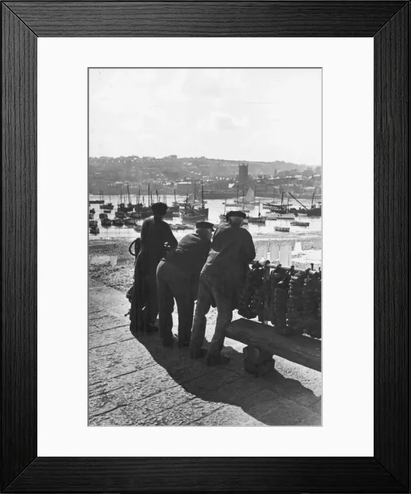 Framed Print : Three Cornish fishermen seen here in St Ives leaning on the harbour railings