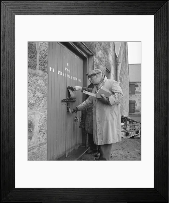 Framed Print : A supervisor at the Glenlivet Distillery seals one of the bonded warehouse where barrels Framed Print : A supervisor at the Glenlivet Distillery seals one of the bonded warehouse where barrels