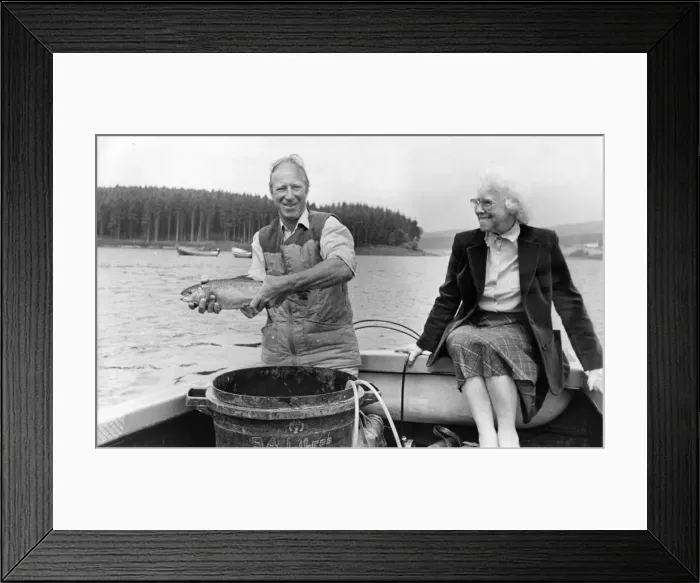 Framed Print : Jack Charlton releases one of the tagged trout at Kielder Reservoir with his mam Cissie