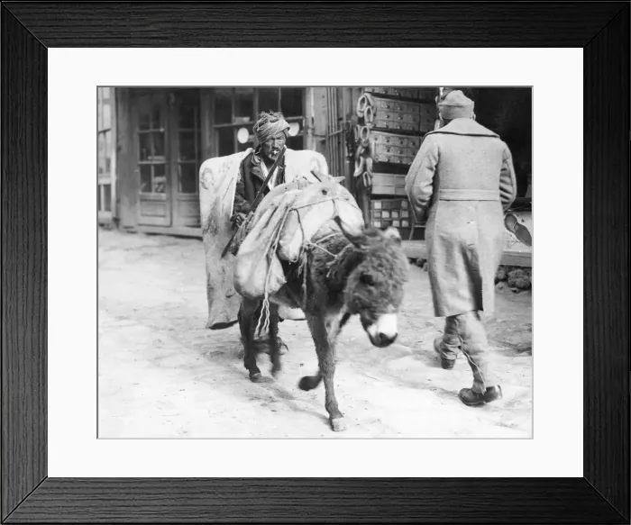 Framed Print : Peasant wearing his winter overcoat brings his goods to market on the back of his donkey Framed Print : Peasant wearing his winter overcoat brings his goods to market on the back of his donkey