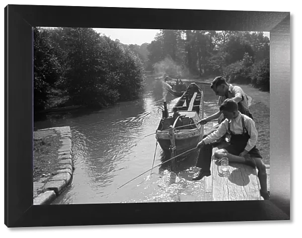 Brothers fishing from the Grand Union Canal lock gates between Watford and Rickmansworth