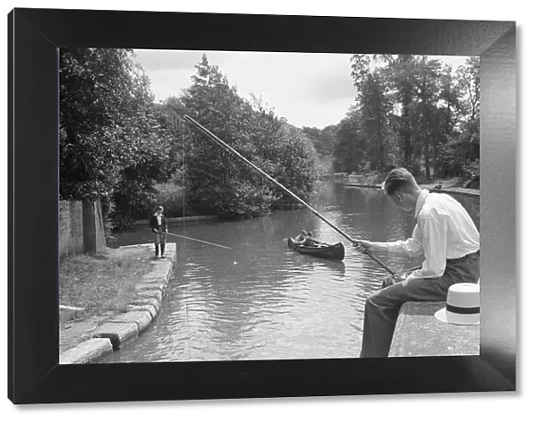 A young angler fishing in the Grand Union Canal between Rickmansworth and Watford