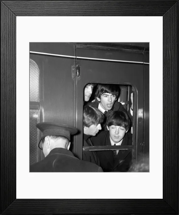 Framed Print : The Beatles peer from a train carriage window at Paddington Station, London Framed Print : The Beatles peer from a train carriage window at Paddington Station, London