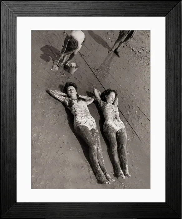 Framed Print : Women Holidaymakers sunbathing on the wet sand wearing swimming costumes bathing suits Framed Print : Women Holidaymakers sunbathing on the wet sand wearing swimming costumes bathing suits