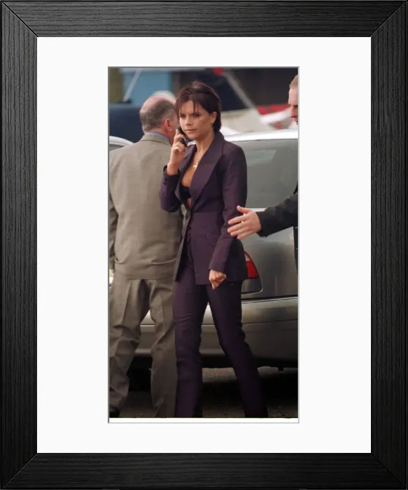 Framed Print : Victoria Adams Posh Spice talks on her mobile telephone as she prepares to leave with Framed Print : Victoria Adams Posh Spice talks on her mobile telephone as she prepares to leave with