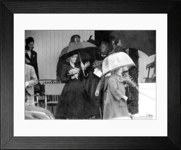 Framed Print : Princess Diana and The Queen Mother hide underneath their umbreallas during a heavy Framed Print : Princess Diana and The Queen Mother hide underneath their umbreallas during a heavy