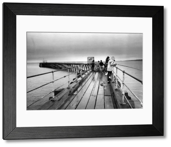 Framed Print : A group of young anglers prepare to enjoy a quite afternoon fishing on Blyth Pier