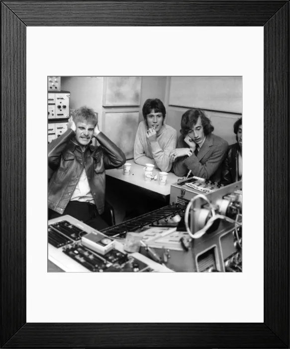 Framed Print : Ray Moore (left) andBarry and Robin Gibb of the Bee Gees pop group listening to Framed Print : Ray Moore (left) andBarry and Robin Gibb of the Bee Gees pop group listening to