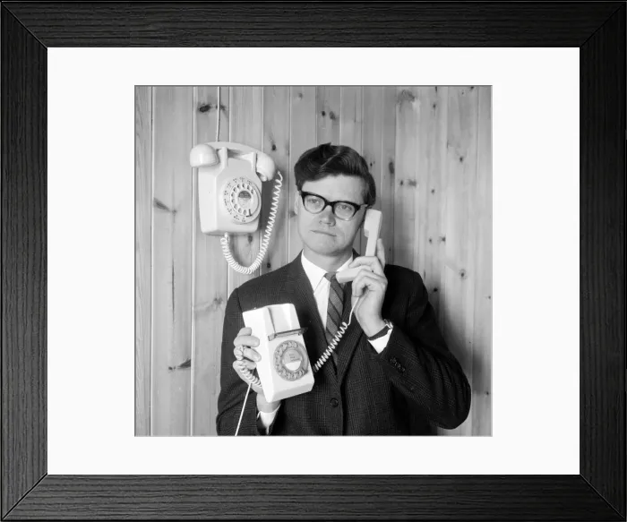 Framed Print : Arthur Smith demonstrates the new trimphone, in contrast to a Dial Telephone mounted