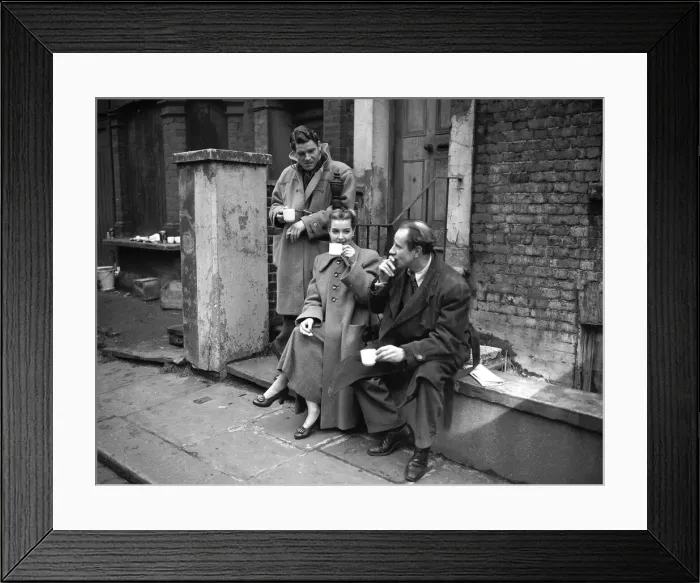 Framed Print : Actors take a break from filming a scene on location at a butchers shop March 1952