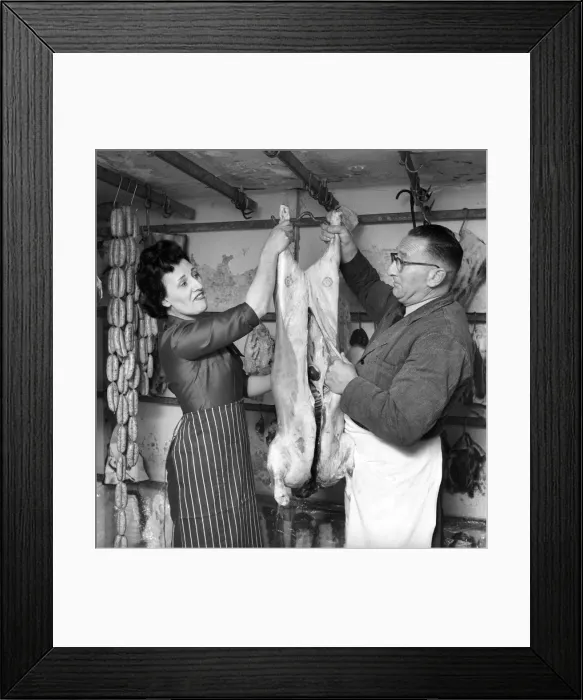 Framed Print : A female butcher seen here at work in her shop with her colleague. 1963 Framed Print : A female butcher seen here at work in her shop with her colleague. 1963