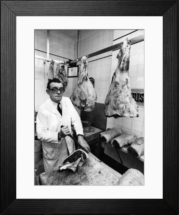 Framed Print : Butcher Bert Sibbet cutting joints in his shop. November 1974 Framed Print : Butcher Bert Sibbet cutting joints in his shop. November 1974