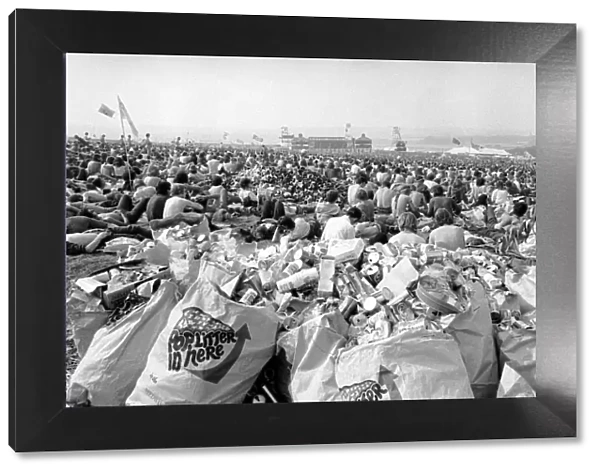 Music fans surrounded by empty cans at The Isle of Wight Festival. 30th August 1970