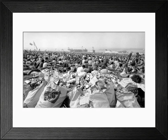 Framed Print : Music fans surrounded by empty cans at The Isle of Wight Festival. 30th August 1970