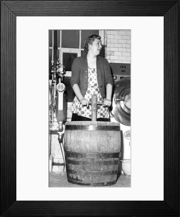 Framed Print : Mrs. Hedley demonstrates the old post-tub method of washing clothes, in February 1960 Framed Print : Mrs. Hedley demonstrates the old post-tub method of washing clothes, in February 1960