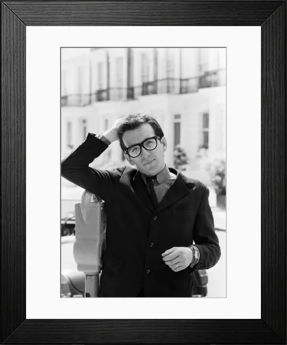 Framed Print : Elvis Costello, the newest sensation on the music scene, standing next to parking machine Framed Print : Elvis Costello, the newest sensation on the music scene, standing next to parking machine