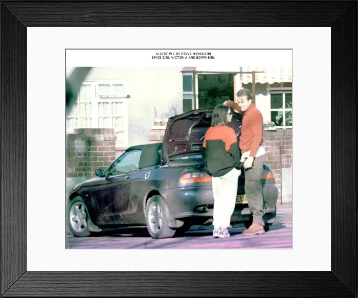Framed Print : Spice Girls Victoria with boyfriend beside car