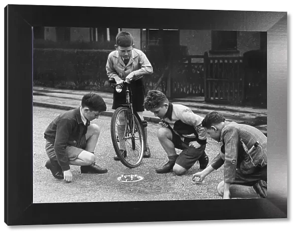 Children playing marbles game in the street, Scotland. 1947