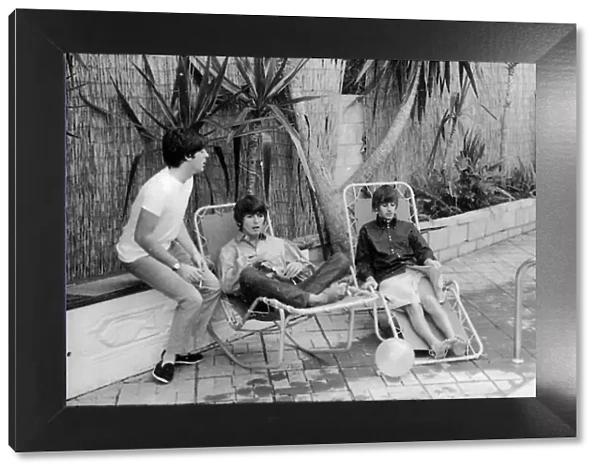 Paul McCartney, George Harrison and Ringo Starr relax on sun loungers at their rented