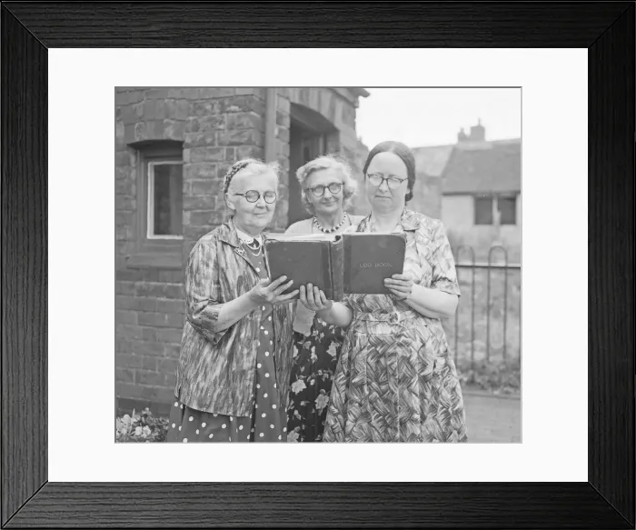 Framed Print : Three teachers looking over the log book at Hawkesbury Church of England School