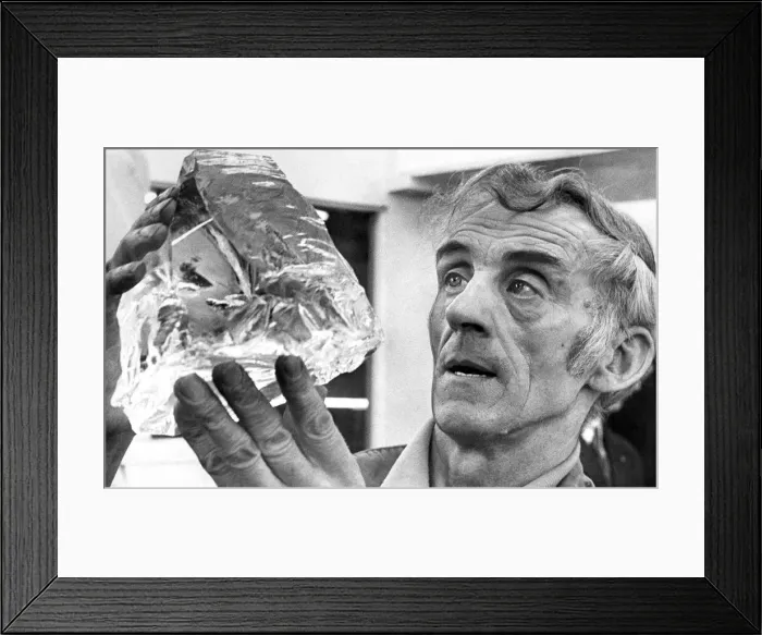 Framed Print : Glass blower Mr. John Gartland examines a chunk of quartz which will be turned into a