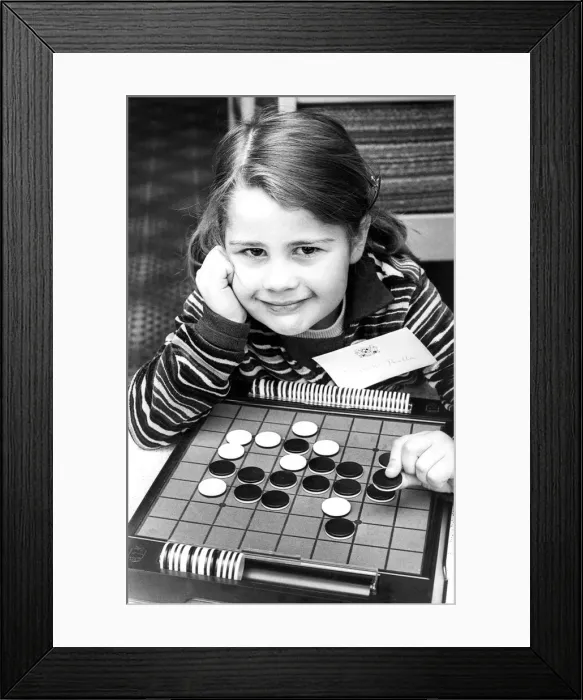 Framed Print : The board game Othello is childs play to four year old Elizabeth Perella in April 1977