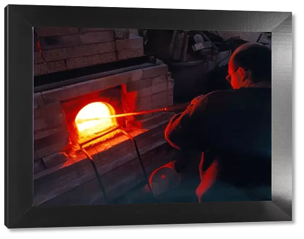 Glass blower Andy Murphy works on one of the furnaces in November 1997