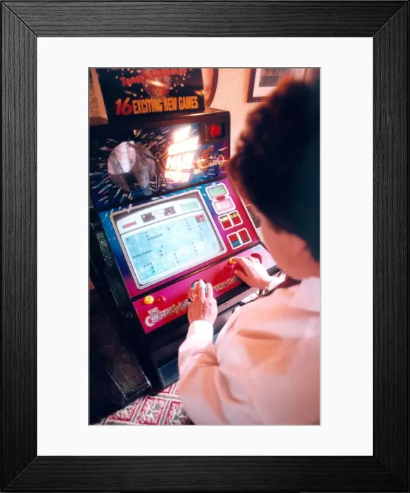 Framed Print : A woman playing on a one armed bandit or electronic gaming machine in November 1999 Framed Print : A woman playing on a one armed bandit or electronic gaming machine in November 1999