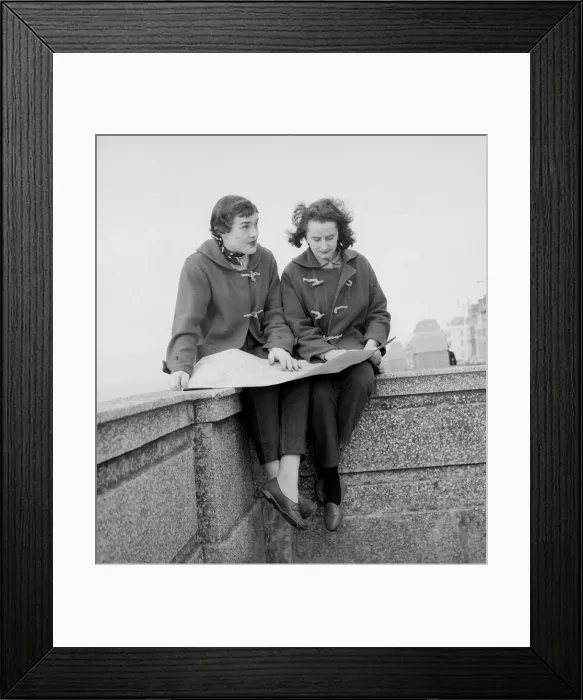 Framed Print : Racing drivers Pat Moss and Ann Wisdom aged 21, study their map on the promenade in Framed Print : Racing drivers Pat Moss and Ann Wisdom aged 21, study their map on the promenade in
