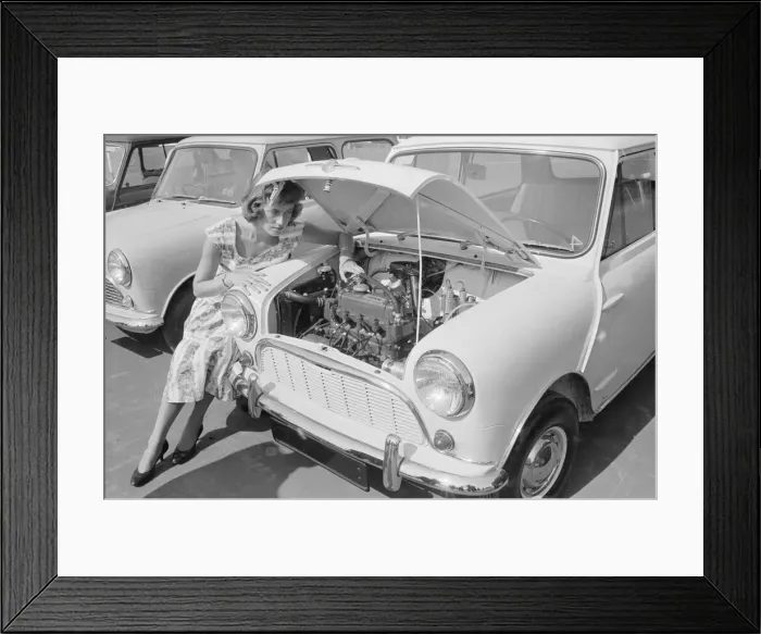 Framed Print : A woman checks the engine of one of the first mini cars designed by Alec Issigonis which