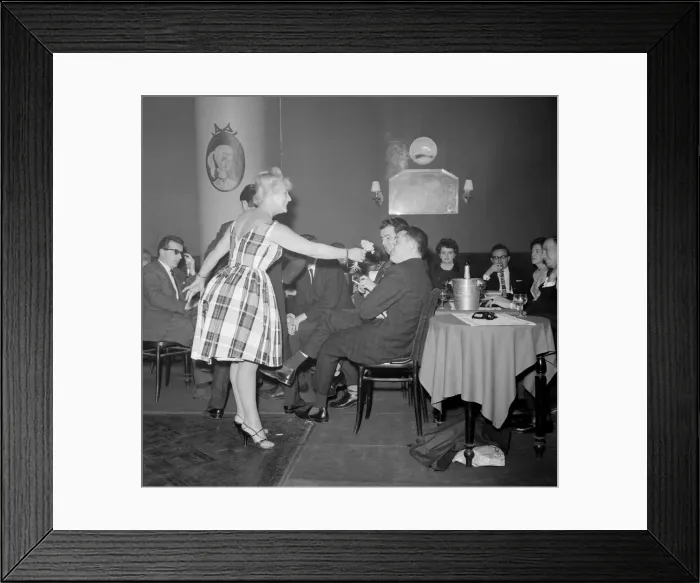 Framed Print : Monte Carlo Rally winner Paddy Hopkirk enjoys the attention of a hostess in a Monte Carlo