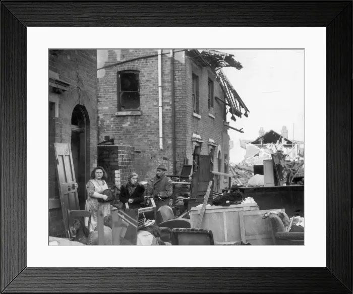 Framed Print : Residents of a Coventry street stand outside their ruined homes after the city was